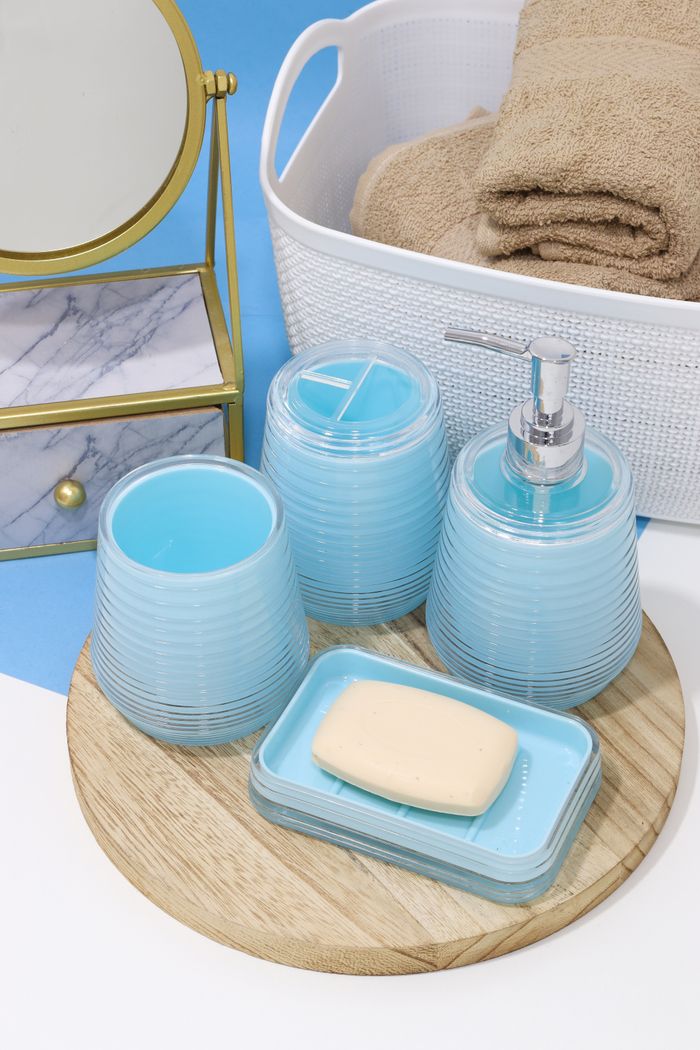 Stylish setup of blue bathroom accessories on a wooden tray.